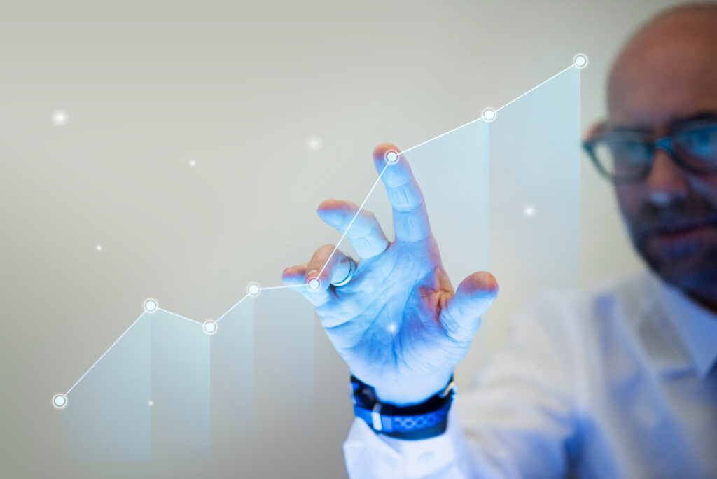 businessman pointing his finger growth graph